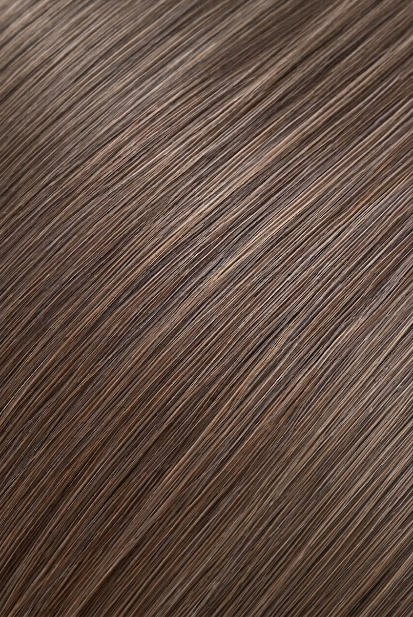 A close-up texture shot of straight, sleek brown hair with subtle warm highlights, filling the entire frame.